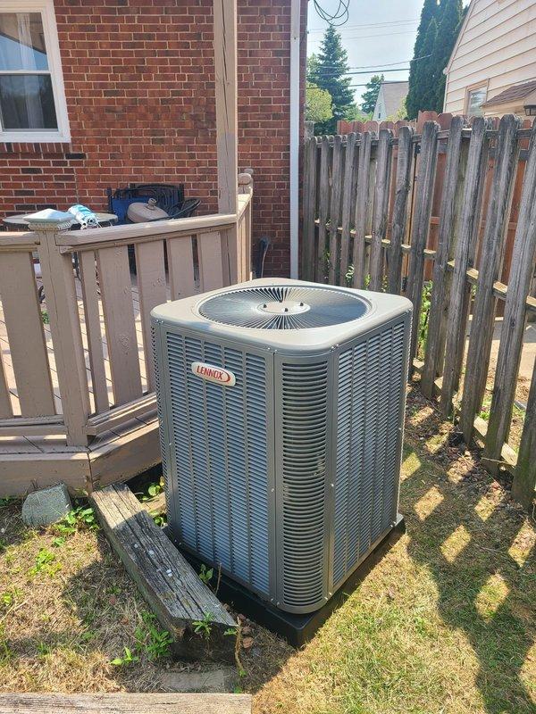 Completed installation of new Lennox air conditioning condenser unit with matching evaporator coil at residential property. Unit was properly positioned on equipment pad in backyard location, with all refrigerant lines connected and tested, reversing valve installed, and system charged to manufacturer specifications. System startup performed successfully with all components operating within normal parameters.