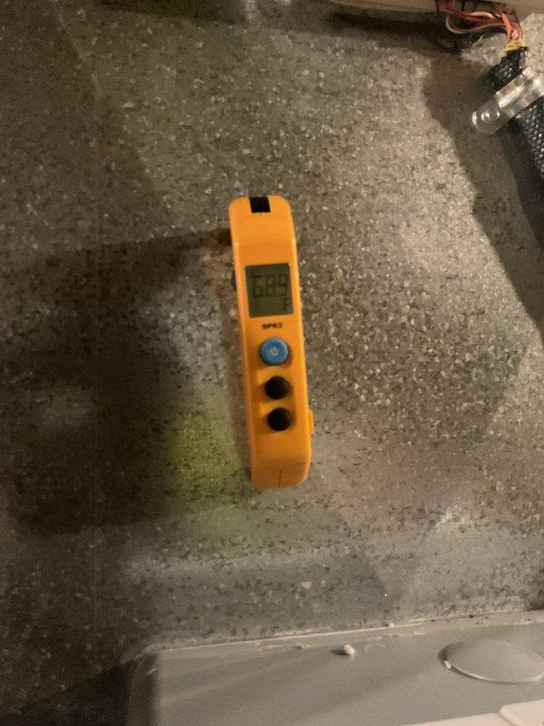 Responded to service call for defective April Air system. Upon arrival, performed diagnostic assessment of outdoor condensing unit and indoor components. Unit exterior showed significant dirt and debris accumulation on coil fins and casing. Utilized digital measuring instrument to obtain temperature and humidity readings, recording 55.5 degrees at measurement point. Inspected refrigerant lines, electrical connections, and condensate drainage system. Documented current system condition with photographic evidence showing soiled outdoor unit and diagnostic equipment readings. System requires further evaluation to determine specific component failure and recommended repairs.