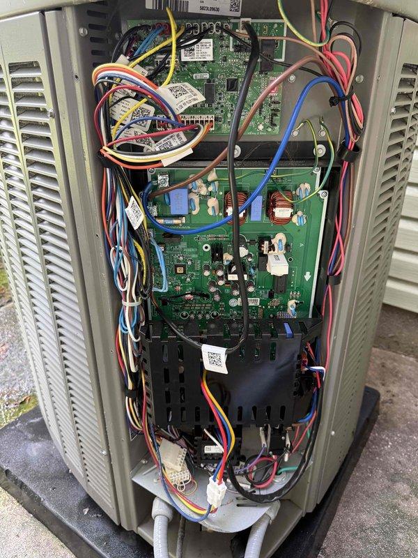 Completed scheduled BS-MVP cooling maintenance visit on 2-year-old outdoor unit. Performed comprehensive system inspection including visual examination of control board and electrical components. Documented circuit board condition showing proper operation of capacitors, DIP switches, LED display, and all surface-mount components. Verified all wire connections secure with proper labeling intact across red, yellow, blue, orange, brown, white, and black conductors. Inspected interior control panel assembly with stacked circuit boards and confirmed all electronic components functioning within normal parameters. Unit operating efficiently with no issues identified during preventive maintenance service.