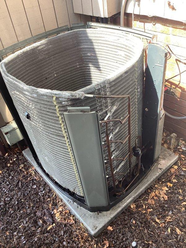 Responded to service call for non-operational outdoor AC condenser unit on 10-year-old system. Upon arrival, found outdoor unit heavily soiled with significant debris accumulation on condenser coils and internal components. Performed thorough inspection revealing excessive dirt, dust, and organic matter blocking airflow through aluminum fins and coating refrigerant coil assembly. Removed access panel and documented severe contamination on back panel and copper refrigerant lines. Cleaned condenser coils using appropriate methods to restore proper airflow and heat transfer efficiency. Cleared debris from unit base and surrounding area. Verified refrigerant line connections and electrical components for proper operation following cleaning. System restored to operational status with improved airflow and cooling capacity.