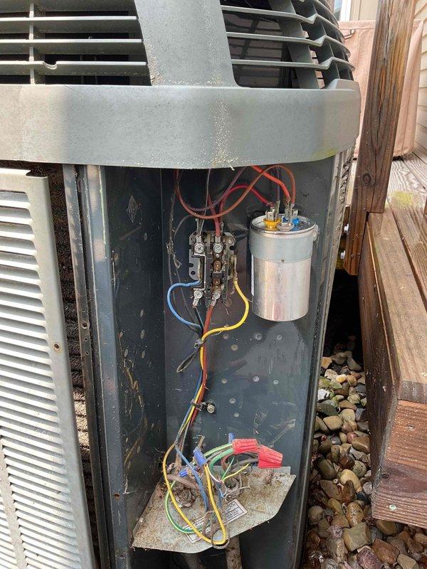 Responded to service call for air conditioning unit running but not cooling. Upon inspection, found evaporator coil completely frozen with significant ice buildup on fins and metallic surfaces. Removed outdoor unit access panel and inspected electrical components including capacitor, contactor, and associated wiring connections. Diagnosed frozen coil condition indicating restricted airflow or low refrigerant charge. System requires defrost cycle completion and further evaluation of refrigerant levels and airflow restrictions to restore proper cooling operation.