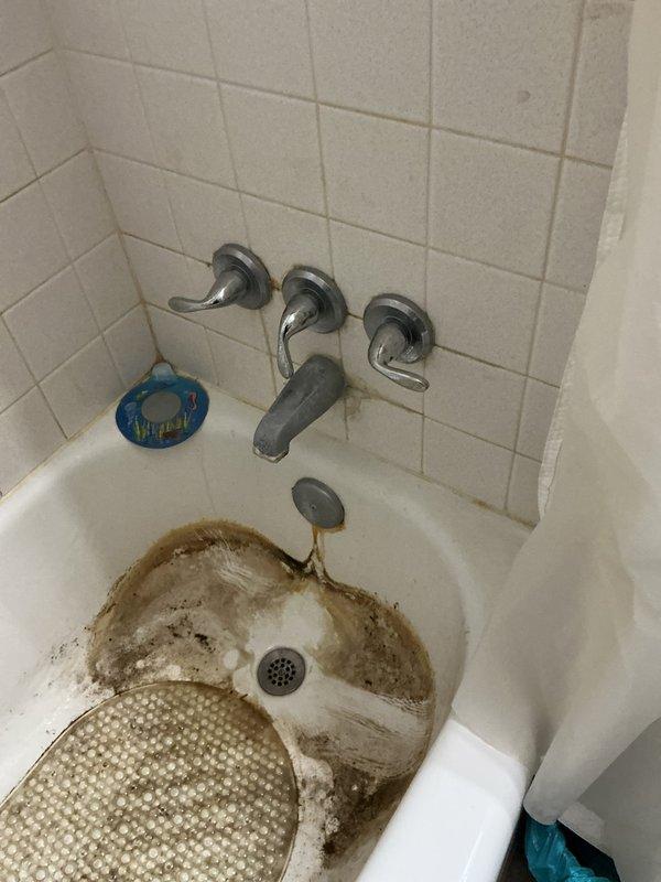 Responded to service call for leaking bathroom faucet. Upon arrival, inspected three-handle tub faucet fixture with chrome handles and central spout. Identified source of leak and performed necessary repairs to stop water dripping. Tested all three handles and spout for proper operation and verified complete seal with no further leakage detected upon completion.