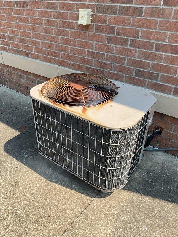 Responded to no cooling complaint on 21-year-old outdoor condensing unit. Upon arrival, verified unit was running but not producing cold air. Performed diagnostic inspection of condenser components including compressor operation, fan motor function, and refrigerant system. Assessed condition of aging equipment showing significant weathering and operational wear consistent with age. Evaluated electrical connections, capacitor performance, and airflow through condenser coil. Due to advanced age of system and extent of service requirements, provided customer with repair options and recommendations for system replacement given equipment has exceeded typical service life expectancy. Applied friends and family discount as requested.