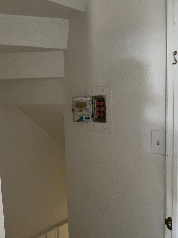 Responded to outlet issues in an 85-year-old residential property. Inspected and serviced electrical junction box with visible terminal connections, replaced defective switch mechanism with illuminated toggle switch in wood-paneled room, and verified proper functionality of all affected circuits and outlets throughout the home.