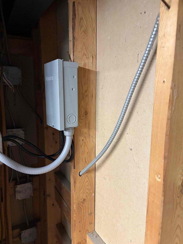 Completed full HVAC system installation including heat pump condenser unit and air handler. Installed electrical junction box and ran conduit for power supply to air handler in interior framed space. Performed vacuum test on refrigerant lines using calibrated digital gauge, achieving proper evacuation at -242 microns with acceptable decay rate of 42 sl/min, confirming system integrity and absence of leaks. System tested and operational.