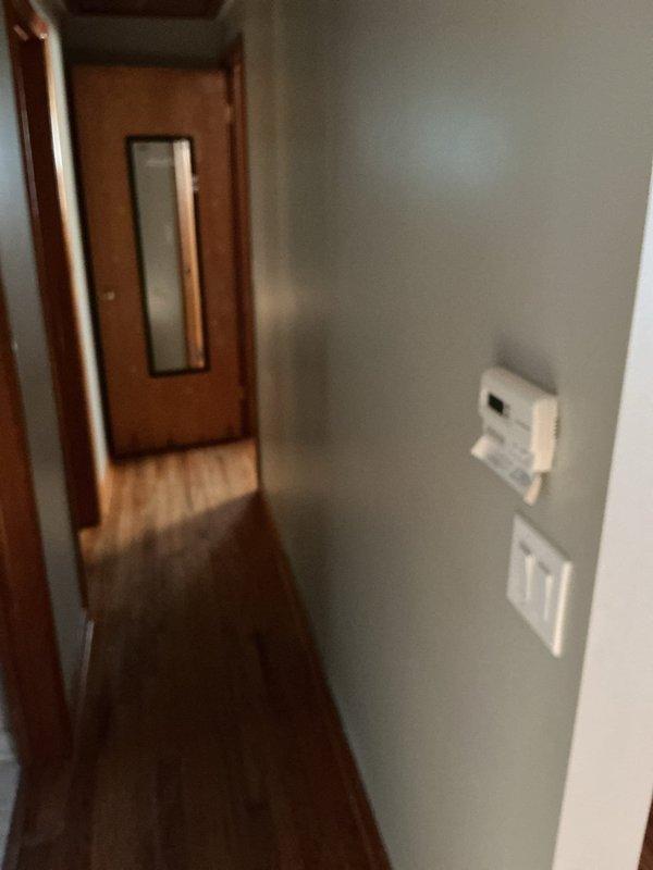 Completed comprehensive residential rewiring project covering multiple rooms throughout the home. Installed new wiring and outlets in living room (5 outlets plus light/fan), dining room (2 outlets with grounding verification), bedroom 1 (5 outlets, center light, and closet light), and bedroom 2 (3 outlets and center light). Added specialized basement electrical work including elevated outlet for computer equipment and south wall outlet, plus new wiring for exterior outlet connection. Verified proper grounding on existing dining room circuits and maintained existing kitchen and bathroom electrical systems. Front entry sconce with right-side switch installation completed as specified.
