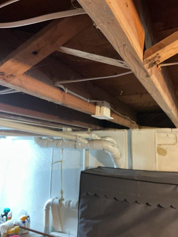 Completed comprehensive residential rewiring project covering multiple rooms throughout the home. Installed new wiring and outlets in living room (5 outlets plus light/fan), dining room (2 outlets with grounding verification), bedroom 1 (5 outlets, center light, and closet light), and bedroom 2 (3 outlets and center light). Added specialized basement electrical work including elevated outlet for computer equipment and south wall outlet, plus new wiring for exterior outlet connection. Verified proper grounding on existing dining room circuits and maintained existing kitchen and bathroom electrical systems. Front entry sconce with right-side switch installation completed as specified.