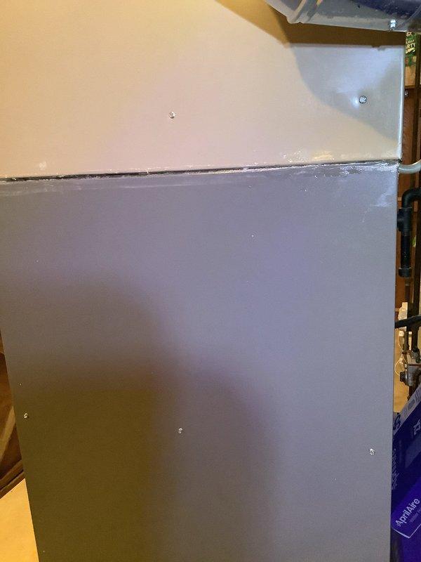 Responded to major water leak originating from furnace coil. Upon arrival, inspected HVAC unit and confirmed active leak from evaporator coil causing water damage to surrounding area. Documented equipment condition and leak source with photos showing affected cabinet panels and drainage components.