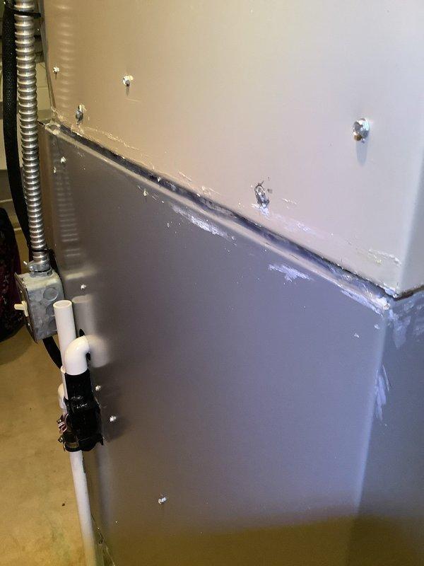 Responded to major water leak originating from furnace coil. Upon arrival, inspected HVAC unit and confirmed active leak from evaporator coil causing water damage to surrounding area. Documented equipment condition and leak source with photos showing affected cabinet panels and drainage components.