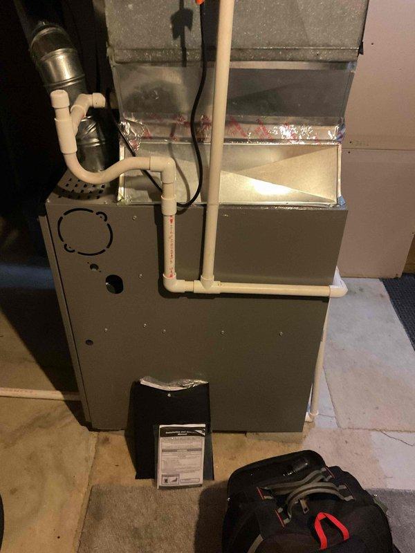 Completed scheduled MVP cooling maintenance visit on 15-year-old residential HVAC system. Performed comprehensive inspection of furnace unit, condensate drainage system including PVC piping and trap assembly, ductwork connections, and associated mechanical components in basement utility room. System found operating within normal parameters; verified proper condensate flow, inspected electrical connections, and confirmed all safety mechanisms functioning correctly.