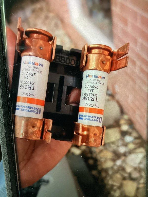 Completed scheduled MVP cooling maintenance visit. Inspected and verified electrical protection components including 35A Ferraz Shawmut TR-33R fuses rated at 250V AC, confirming proper operation and secure mounting in fuse holder assembly. Examined air handler interior and ductwork connections, noting normal dust accumulation on foil-faced insulation and junction seams consistent with system operation.