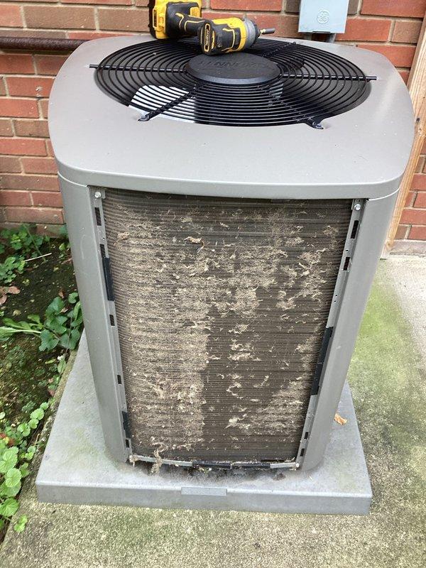 Completed preventive maintenance visit on residential air conditioning system. Performed thorough inspection of outdoor condenser unit, which exhibited heavy accumulation of dirt, debris, and organic matter on exterior coil surfaces that was significantly restricting airflow and reducing system efficiency. Removed access panels to inspect internal electrical components, including capacitor, contactor, and wiring connections. All electrical connections were found to be secure with no signs of overheating or deterioration. Unit operational at time of inspection.