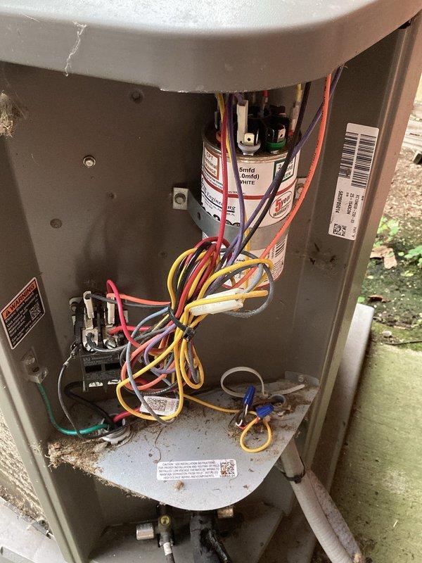 Completed preventive maintenance visit on residential air conditioning system. Performed thorough inspection of outdoor condenser unit, which exhibited heavy accumulation of dirt, debris, and organic matter on exterior coil surfaces that was significantly restricting airflow and reducing system efficiency. Removed access panels to inspect internal electrical components, including capacitor, contactor, and wiring connections. All electrical connections were found to be secure with no signs of overheating or deterioration. Unit operational at time of inspection.