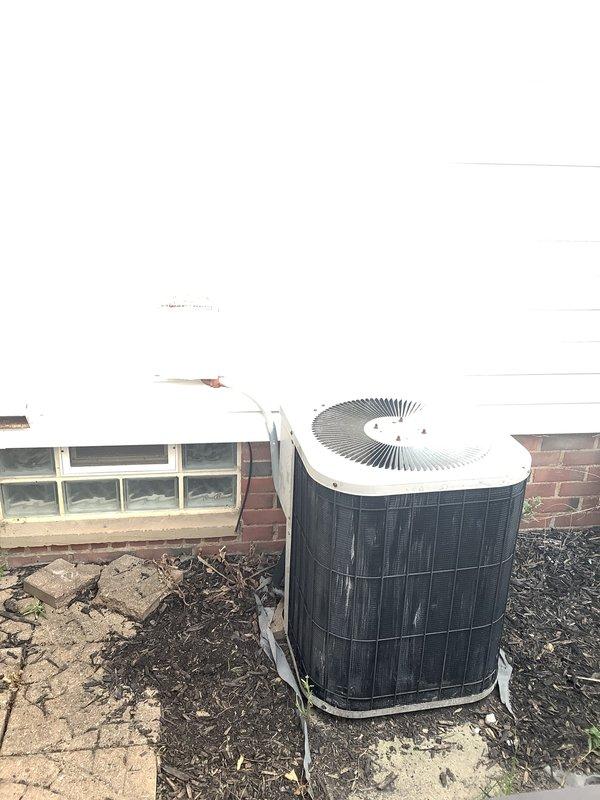 Completed furnace and air conditioning replacement estimate for residential property. Evaluated existing outdoor condenser unit positioned against brick exterior, noting weathered condition and accumulated debris in nearby gutter system. Applied applicable senior and military discounts to estimate pricing.