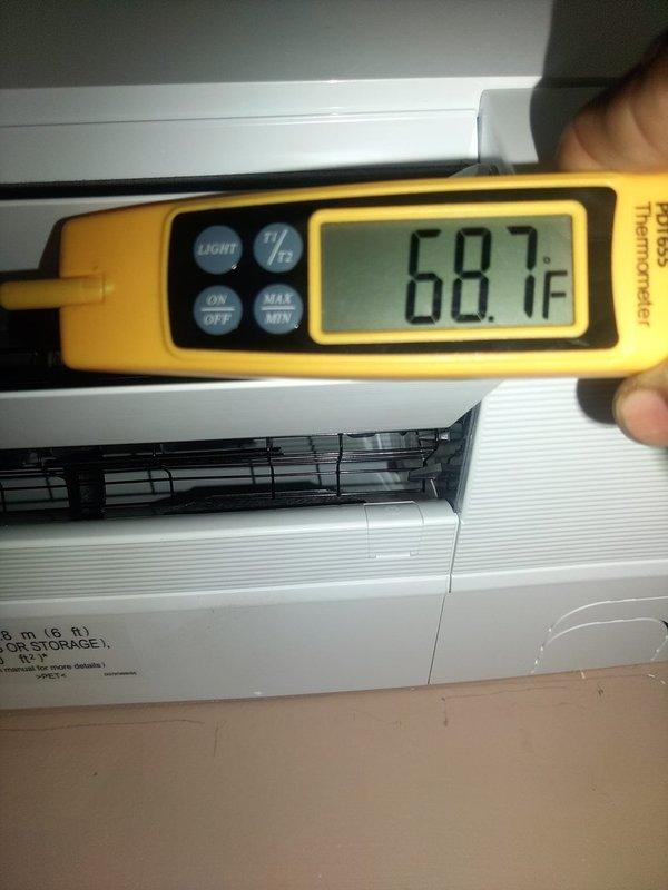Completed installation of single-head Mitsubishi mini-split system in residential space. Mounted indoor air handler unit on interior wall above shelving area, installed outdoor condenser, ran refrigerant lines and electrical connections, and performed system startup and testing. Verified proper operation with temperature readings confirming unit cooling to 68.7°F at time of completion.