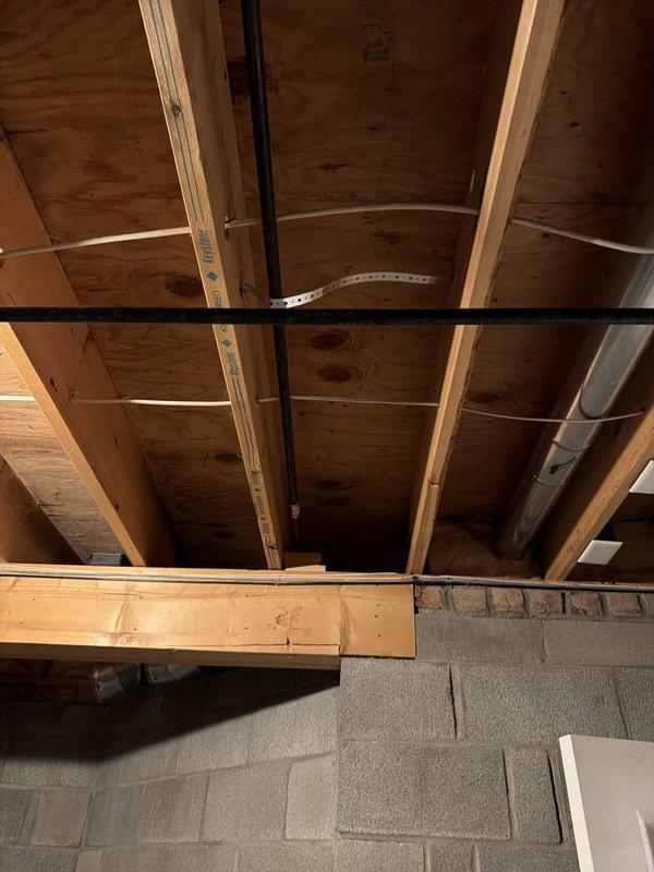 Installed a new 1/2-inch gas line in the basement, tying into the existing 1-inch main gas line near the furnace. Routed the line through the basement structure, stubbed it out through the back of the home, and terminated it with a shut-off valve for outdoor gas grill connection.