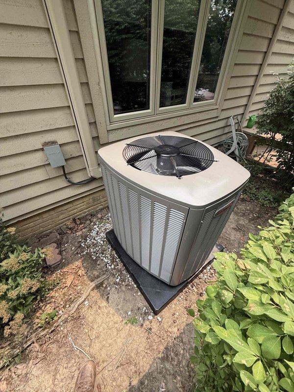 Completed installation of WeatherKing air conditioning system with matching evaporator coil. Installed outdoor condenser unit on protective pad with proper clearances, established refrigerant line connections, and wired electrical disconnect with 30-amp Bussmann fuses for overcurrent protection. System tested and operational.