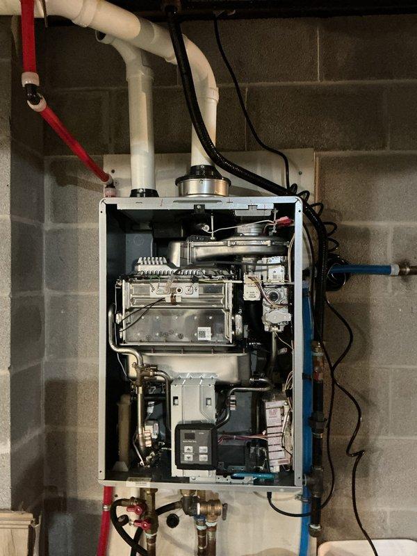 Performed complete descaling service on wall-mounted tankless water heater unit. Removed and cleaned inlet filter screen, which showed good condition with no significant debris accumulation. Flushed heat exchanger assembly with descaling solution to remove mineral buildup and maintain optimal heat transfer efficiency. All internal components, including pumps, valves, and control modules, were inspected and found to be functioning properly. Unit was reassembled and tested for proper operation following the maintenance procedure.