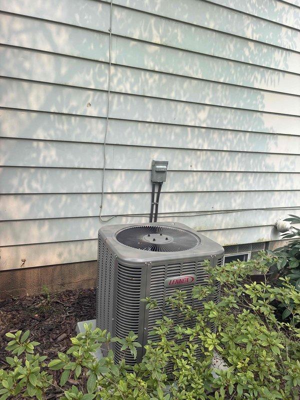 # HVAC Maintenance - Cooling

Completed preventive maintenance inspection on 8-year-old Lennox outdoor condensing unit and indoor air handler system. Performed comprehensive cooling system evaluation including visual inspection of blower wheel assembly, which showed normal dust accumulation on squirrel cage fan blades and motor shaft components. Examined outdoor condenser unit mounted on exterior wall with proper clearance from landscaping vegetation. Verified electrical conduit connections, assessed louvered panel condition, and confirmed fan blade operation through protective grille. System operating within normal parameters for unit age with all components functioning as designed.