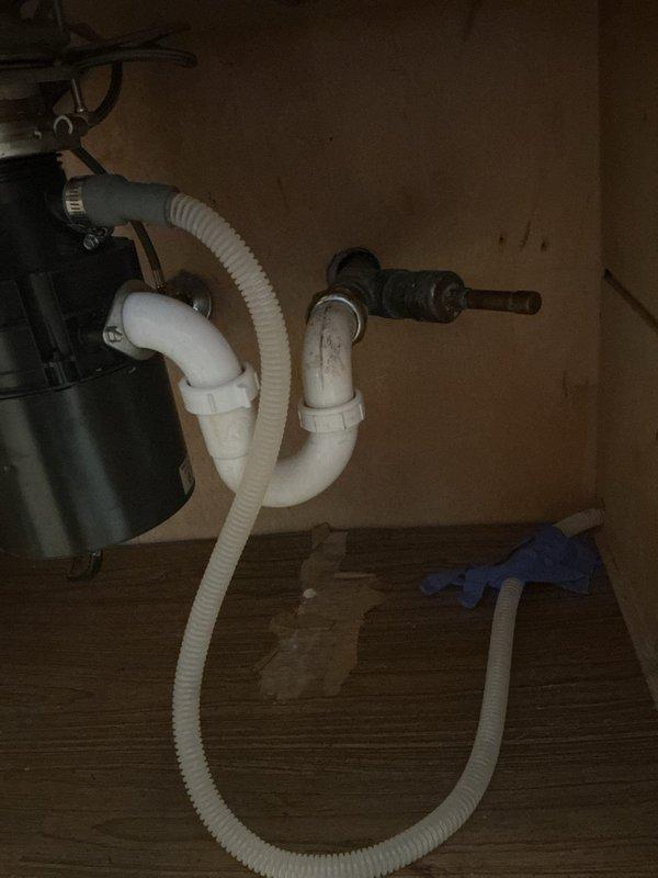 Responded to service call for garbage disposal issue at residential property. Upon inspection, assessed the existing disposal unit and drainage system beneath kitchen sink. Verified proper connection of P-trap assembly, drain lines, and dishwasher discharge hose to disposal unit. Tested disposal operation, checked mounting assembly and electrical connections, and ensured all plumbing connections were secure with no leaks present. System restored to full working order.