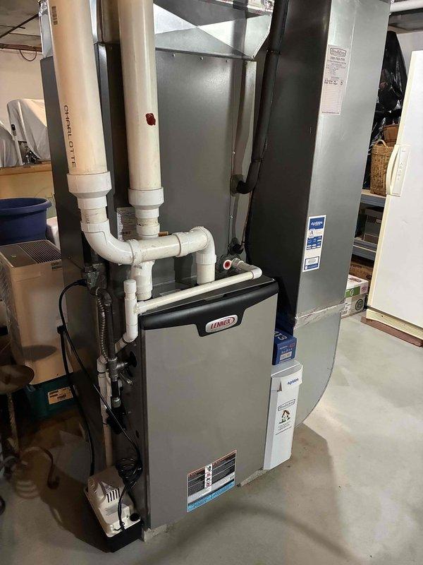 Completed MVP cooling maintenance visit on residential Lennox HVAC system. Performed system inspection, verified refrigerant charge at 6.0 lbs using Elitech digital scale showing stable readings, and confirmed proper operation of furnace unit with associated PVC venting and drainage components. All equipment found operating within normal parameters with no issues identified.