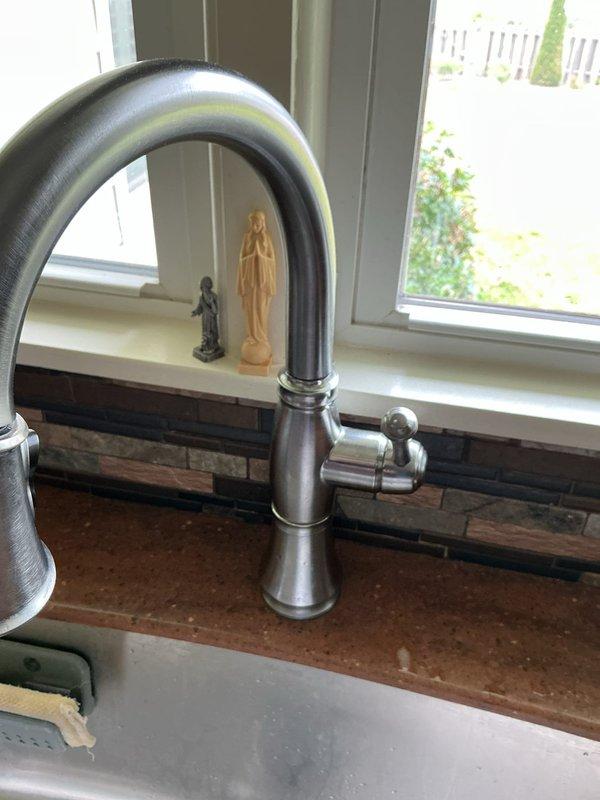 Responded to service call for multiple plumbing issues including two faucets requiring repair. Kitchen faucet addressed for active leak; bathroom faucet repaired for loose handle operation. Inspected two drain systems: one drain evaluated for potential obstruction requiring future snaking service, main bathroom drain assessed for clog condition. Examined water filtration system housing fittings for proper function and connection integrity. Evaluated expansion tank for potential air infiltration issues affecting system pressure regulation. Documented conditions with photographs of kitchen sink faucet assembly with pull-down sprayer and bathroom tub/shower valve with single-handle control.