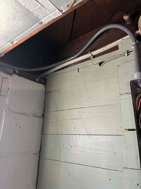 Installed new AC circuit with proper wiring and conduit routing in attic space. Work included mounting electrical panel with dual-row circuit breaker configuration, running metallic and flexible conduit from panel to equipment location, and completing all necessary connections per code requirements for dedicated air conditioning power supply.