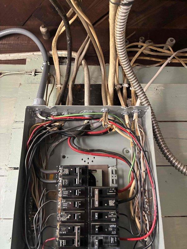 Installed new AC circuit with proper wiring and conduit routing in attic space. Work included mounting electrical panel with dual-row circuit breaker configuration, running metallic and flexible conduit from panel to equipment location, and completing all necessary connections per code requirements for dedicated air conditioning power supply.