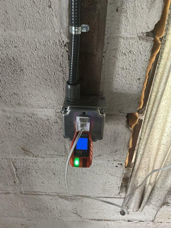 Installed a dedicated 20-amp circuit from the main electrical panel through the attic to a junction box, then ran PVC conduit across the metal roof to the garage terminating at a second junction box. Installed a new GFCI receptacle in the garage, added a single-pole switch, and rewired the existing garage lighting fixture to complete the circuit upgrade.