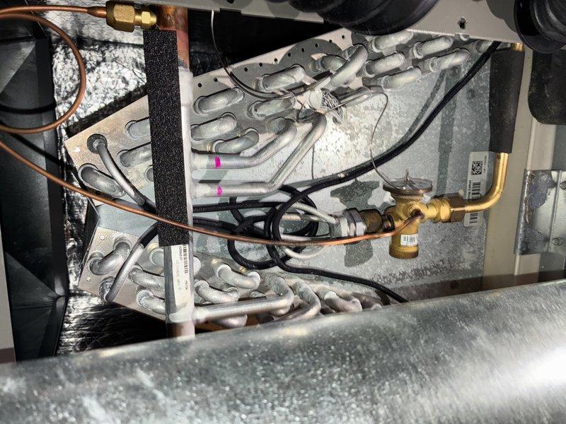 Completed MVP cooling maintenance visit on residential HVAC system. Performed comprehensive inspection of air handler components, including blower wheel assembly which showed moderate dust accumulation on blades. Inspected evaporator coil with serpentine heat exchanger configuration, verifying proper refrigerant line connections and insulation integrity. All copper piping, brass fittings, and electrical connections found secure and functioning properly. System operating within normal parameters.