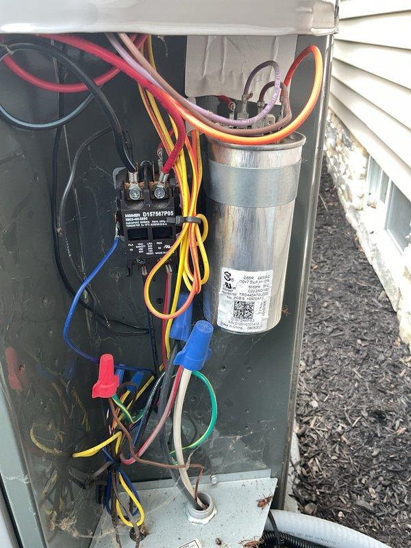 Responded to service call for 2-year-old American Standard air conditioning system experiencing loud noise during startup and shutdown cycles affecting entire residence. Upon arrival, performed visual inspection of outdoor condenser unit and removed access panel to examine electrical components. Tested capacitor under load conditions and verified proper microfarad ratings and voltage specifications. Inspected contactor operation, evaluated all wire connections for tightness and signs of arcing or heat damage, and checked refrigerant line connections. Determined system was operating within normal parameters; advised customer that startup and shutdown noise can be characteristic of certain compressor designs and confirmed no immediate component failures were present. All electrical connections were secure, capacitor tested within acceptable range, and contactor showed proper operation. Reinstalled access panel and restored unit to service.