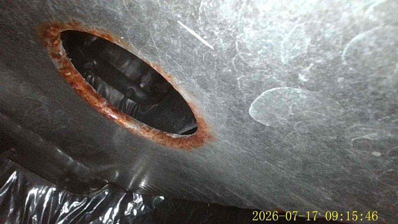Responded to no cool call on 19-year-old air conditioning system. Upon arrival, confirmed unit was running but not producing cold air. Conducted diagnostic inspection revealing severely corroded evaporator coil with visible rust deterioration around access ports and seams, indicating refrigerant leak and extensive age-related degradation. Documented equipment condition with photos showing significant corrosion, rust staining, and compromised metal integrity on coil housing and ductwork connections. Due to advanced age of system and extent of deterioration, recommended full system replacement as most cost-effective solution versus repair of failed components.
