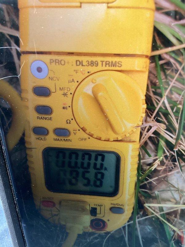 Responded to hail damage assessment request for outdoor mini-split condenser unit. Conducted thorough visual inspection of equipment, documenting extensive rust staining on fan guard and top rim, along with weathered concrete pad showing algae growth. Performed electrical diagnostics using digital multimeter to verify system functionality and assess potential component damage from hail impact. Documented unit condition with photographs and provided customer with detailed repair quote based on findings.