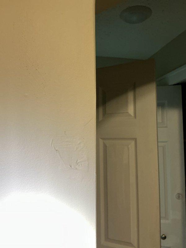 Responded to a shower leak causing water damage to the kitchen ceiling below. Upon arrival, accessed the plumbing system through the wall to locate the source of the leak. Investigation revealed corroded plumbing components with significant rust staining on vertical supply lines behind the shower/tub enclosure. Cut an access opening in the wall to expose the affected pipes and framing. Identified the failed connection causing water to penetrate through the floor assembly into the ceiling cavity below. Repaired the leaking plumbing connections, replaced corroded components, and verified proper water flow and drainage. Documented the condition of existing pipes and repair work with photographs for record-keeping purposes.