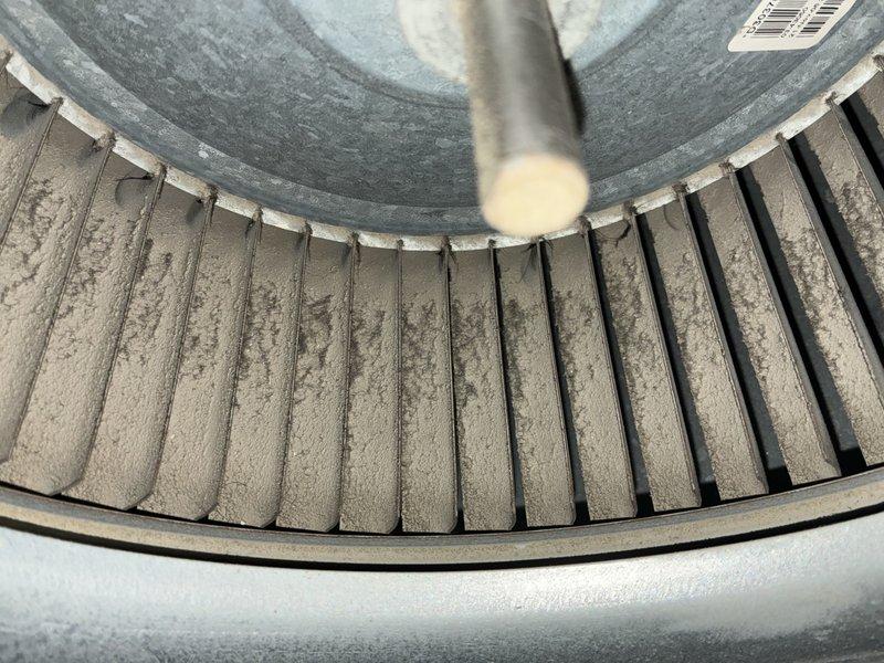 Completed BS-MVP cooling maintenance visit on 12-year-old air conditioning system. Upon inspection, discovered significant dust and debris accumulation on blower wheel assembly, with thick lint-like material coating the blades and restricting airflow efficiency. Cleaned blower wheel thoroughly to restore proper air circulation. Inspected outdoor condenser unit, which showed normal operating condition with adequate clearance from surrounding vegetation. Verified system functionality and confirmed unit is operating within normal parameters for continued service.
