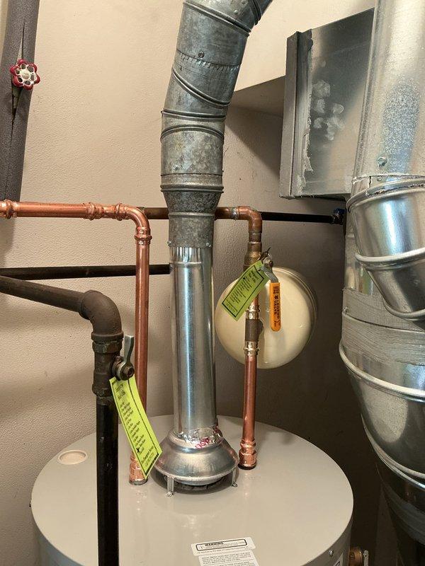 Removed existing leaking water heater and installed new Bradford White 40-gallon residential water heater with 6-year manufacturer warranty. Unit was positioned in water pan and lowered to appropriate height to utilize existing ball valve. Added thermal expansion tank to system and ran drain line from water pan to floor drain in mechanical room. Eliminated sharkbite fitting on hot water side and properly tied back into existing copper water line using permanent connections. All connections tested and verified leak-free upon completion.