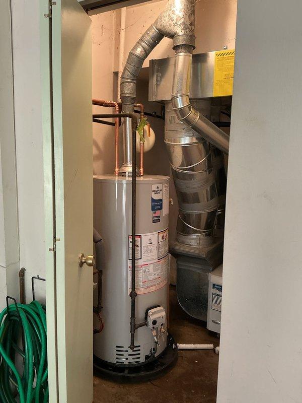 Removed existing leaking water heater and installed new Bradford White 40-gallon residential water heater with 6-year manufacturer warranty. Unit was positioned in water pan and lowered to appropriate height to utilize existing ball valve. Added thermal expansion tank to system and ran drain line from water pan to floor drain in mechanical room. Eliminated sharkbite fitting on hot water side and properly tied back into existing copper water line using permanent connections. All connections tested and verified leak-free upon completion.