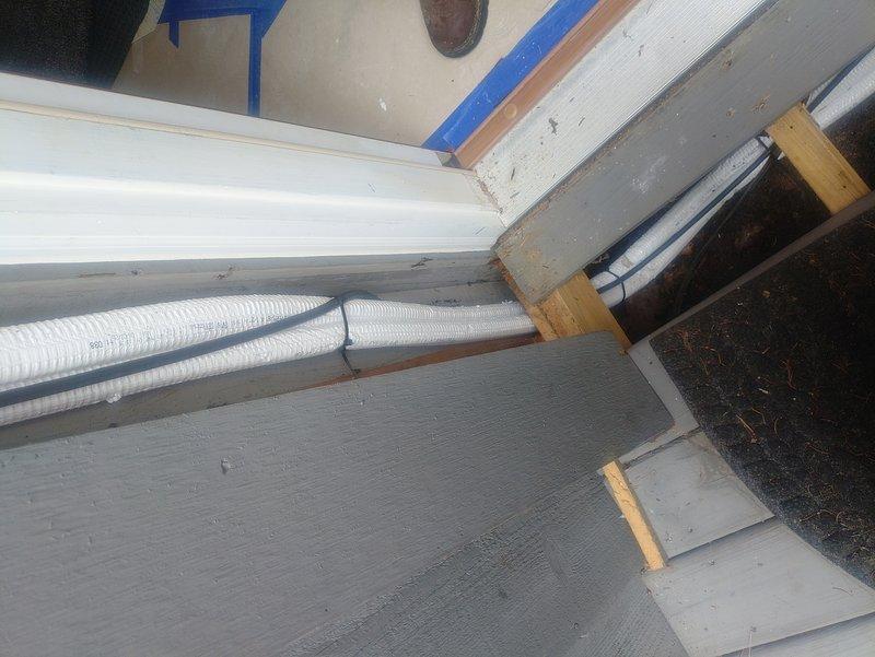 Performed follow-up inspection on recently installed mini split system to address outstanding installation issues. Documented missing cover components, unlevel unit positioning, and improper routing of refrigerant lines and condensate drain requiring cleanup and securing. Identified concerns with protective cover installation over condenser coil fins that may impact airflow and serviceability, recommending corrective measures to ensure optimal system performance and compliance with manufacturer specifications.