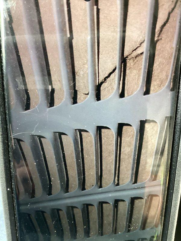 Completed routine maintenance on 19-year-old air conditioning system as part of recurring MVP cooling service. Inspected evaporator coil through access panel, noting condensation and dust accumulation on viewing surface, and evaluated air filter condition within the air handler unit, observing dust buildup on filter media and housing assembly.