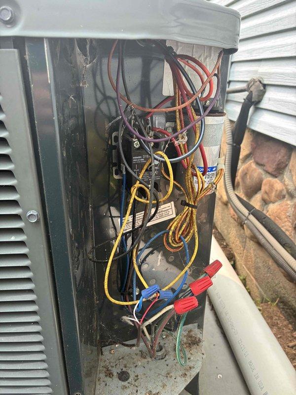 Performed comprehensive AC tune-up on outdoor condensing unit. Conducted electrical diagnostics using digital multimeter, measuring voltage and amperage at control board and verifying proper electrical connections throughout the system. Inspected wiring compartment, documented wire routing and connections, and confirmed all components operating within normal parameters.