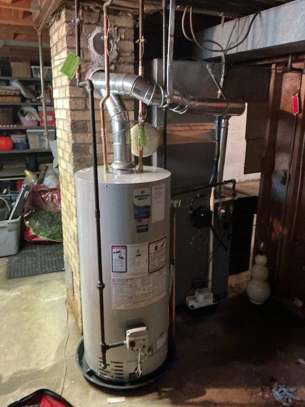 Replaced 40-gallon short water heater with code-compliant installation including required upgrades. Installed new copper supply piping, proper venting, and safety components per current plumbing code requirements. All parts were pre-staged and installation completed with water heater kit including connections, fittings, and necessary hardware for full system functionality.