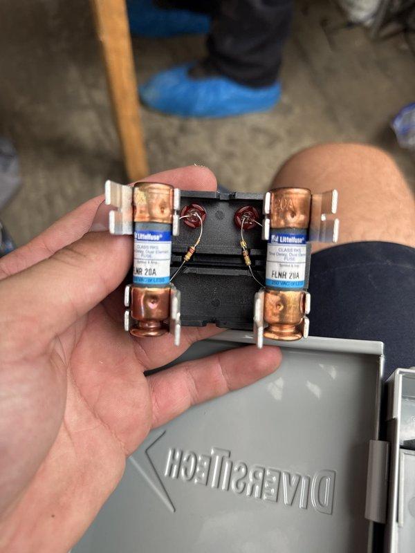 Completed installation of a 90% efficiency furnace and air conditioning system. Installed new electrical components including Littelfuse FLNR 20A fuses with proper wiring connections, established refrigerant line connections with brass service valves, and routed flexible conduit and copper refrigerant lines through the unit compartment. All components tested and operational upon completion.