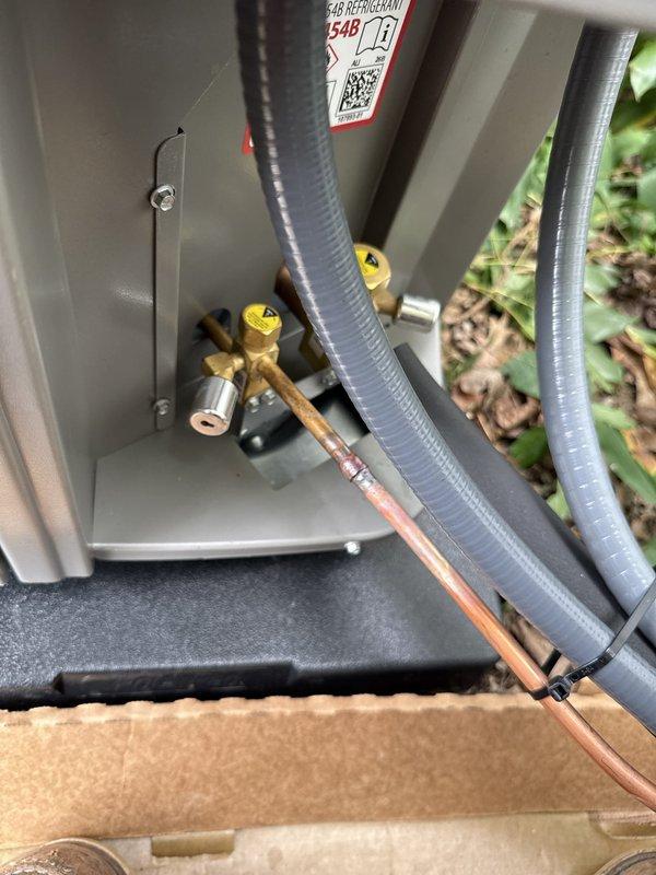 Completed installation of a 90% efficiency furnace and air conditioning system. Installed new electrical components including Littelfuse FLNR 20A fuses with proper wiring connections, established refrigerant line connections with brass service valves, and routed flexible conduit and copper refrigerant lines through the unit compartment. All components tested and operational upon completion.
