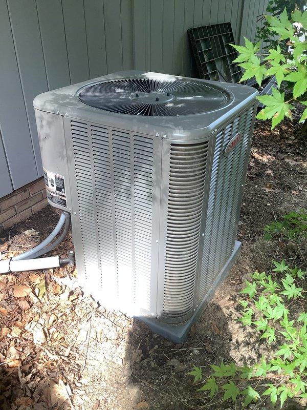Responded to service call for 3-year-old Lennox central air conditioning unit with reported cooling failure, non-operational outdoor fan motor, and electrical odor. Upon arrival, performed visual inspection of condenser unit and confirmed outdoor fan motor was not engaging during compressor cycle. Detected burnt electrical smell emanating from fan motor assembly, indicating motor winding failure or capacitor breakdown. Tested dual run capacitor with multimeter and found fan capacitor section reading out of specification. Replaced failed dual run capacitor with OEM-equivalent component rated for system specifications. Cycled system through multiple start sequences to verify proper fan motor operation and confirm elimination of electrical odor. Checked amperage draw on fan motor and compressor to ensure both components operating within manufacturer specifications. Inspected all electrical connections at contactor and capacitor for signs of arcing or heat damage. Verified proper refrigera