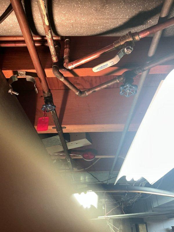 Responded to service call back for damaged gate valve that occurred during previous waterline installation. Upon arrival, inspected the plumbing system in the ceiling space and confirmed the blue-handled gate valve sustained damage when water service was restored. Replaced the faulty gate valve with new unit, ensuring proper connection to existing copper piping. Tested system for leaks and verified full water flow restoration. All connections secured and system returned to normal operation.