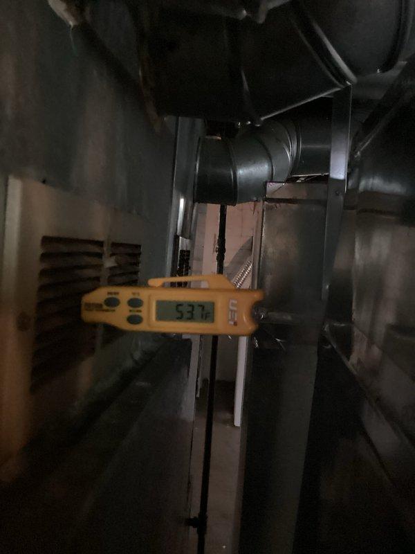 Responded to service call for two-year-old AC system experiencing refrigerant line freezing on both indoor and outdoor components during high outdoor temperatures and continuous operation. Performed diagnostic testing using digital instruments to measure supply air temperature (53.7°F recorded) and assessed refrigerant line conditions throughout the system. Investigation revealed inadequate airflow across the evaporator coil as the root cause of freezing, likely due to restricted air movement through the system during extended runtime periods under peak load conditions.