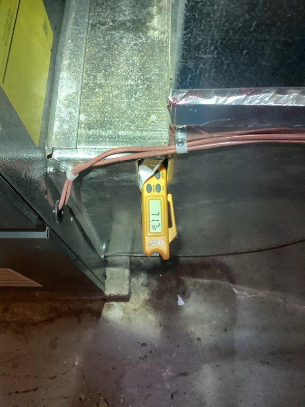 Responded to service call for two-year-old AC system experiencing refrigerant line freezing on both indoor and outdoor components during high outdoor temperatures and continuous operation. Performed diagnostic testing using digital instruments to measure supply air temperature (53.7°F recorded) and assessed refrigerant line conditions throughout the system. Investigation revealed inadequate airflow across the evaporator coil as the root cause of freezing, likely due to restricted air movement through the system during extended runtime periods under peak load conditions.