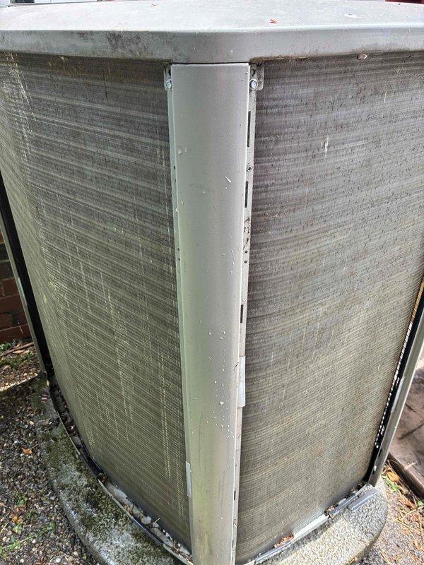 Performed cooling maintenance on an eight-year-old electric air conditioning system with gas furnace setup located in basement. Inspected outdoor condenser unit which showed significant dirt accumulation, debris buildup on coil fins, and algae growth on exterior panels. Addressed customer concern regarding AC failure during power outages and discussed scheduling future heating maintenance.
