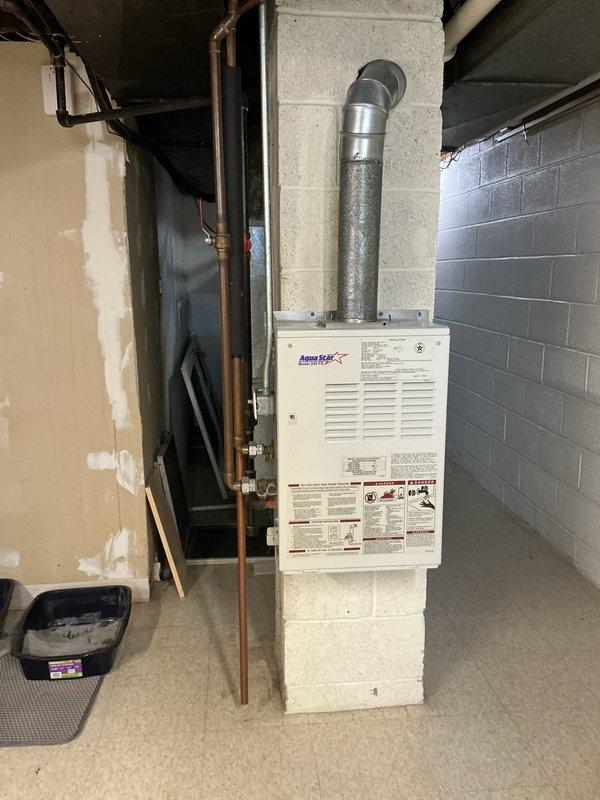 Responded to service call for intermittent operation of tankless water heater. Upon arrival, performed diagnostic assessment of the unit mounted in basement utility area. Inspected the tankless water heater system, including copper supply piping, gas connections, and exhaust venting. Evaluated electrical connections and control board functionality to identify cause of intermittent operation. Documented equipment condition through photographic record showing wall-mounted unit with proper venting configuration and associated plumbing connections. Diagnostic findings were reviewed and repair options presented for intermittent heating issue.