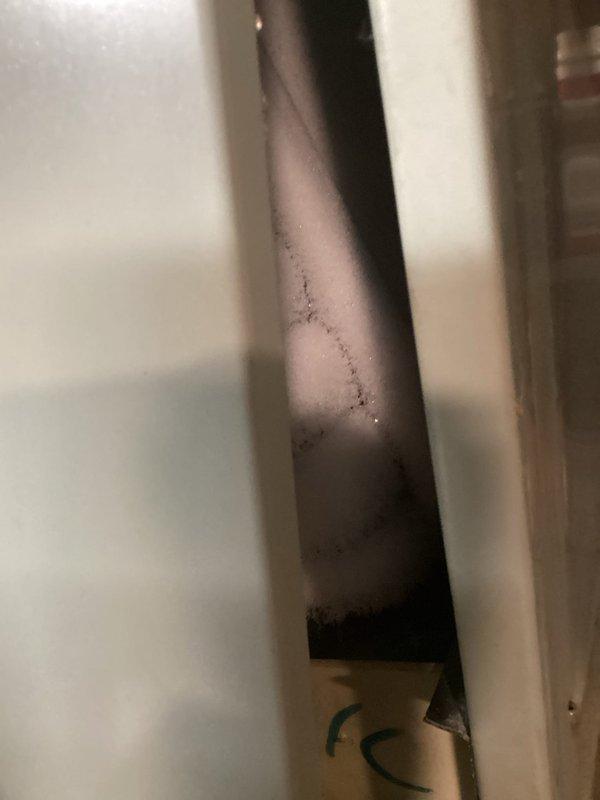 Responded to no-cool complaint on 27-year-old residential AC system with ice formation on refrigerant lines and inadequate airflow to upper level. Upon inspection, found heavy condensation on suction line and evaporator coil frozen due to severely restricted airflow. Diagnosed frozen evaporator coil caused by dirty air filter and blocked return air pathways. Shut down system to allow complete ice melt, replaced clogged air filter, and cleared obstructed return air grilles. Verified blower motor operation and capacitor readings within acceptable range. After defrost cycle completion, restarted system and confirmed proper airflow restoration with suction line temperature returning to normal operating range. Advised customer that while immediate cooling function has been restored, the advanced age of the 1999 unit warrants consideration for replacement due to declining efficiency and increasing likelihood of compressor or other major component failure. Documented exterior disconnect box c